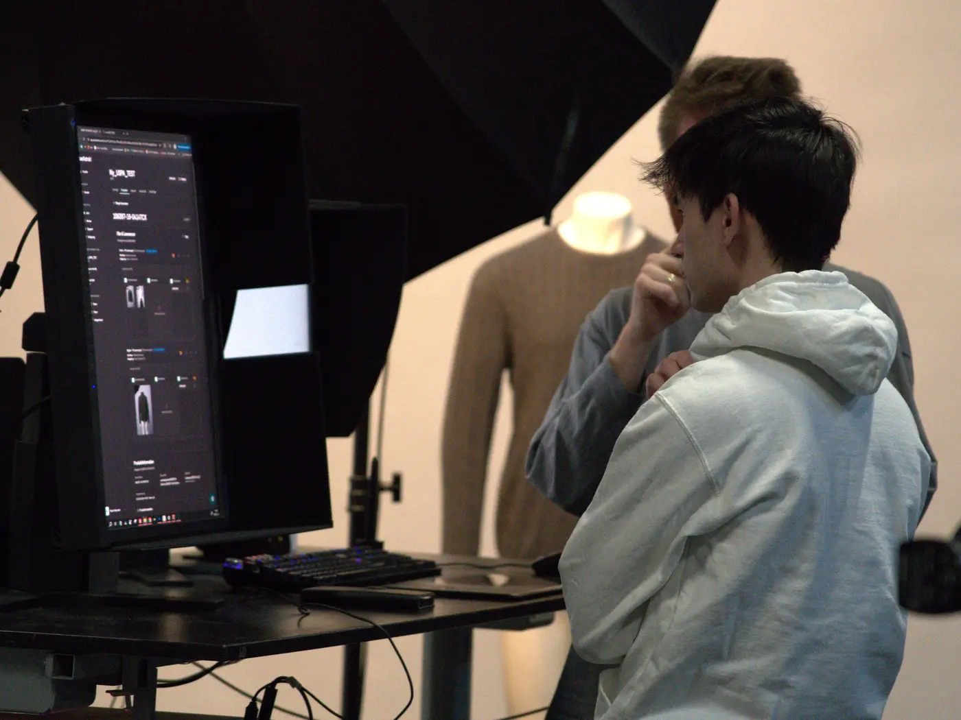 Photographer and assistant at the tethered workstation, with images landing directly in PixelAdmin on screen